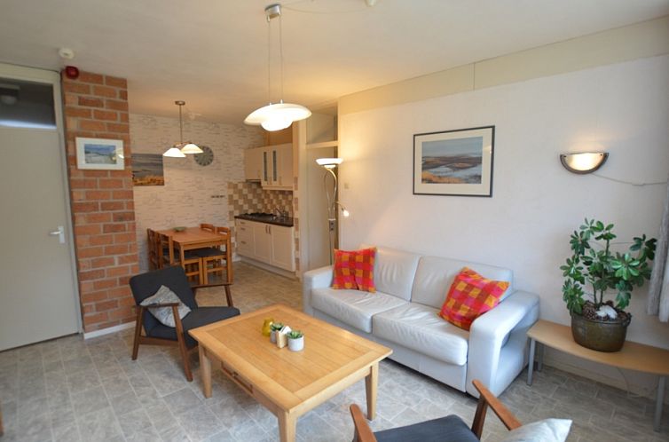 Cozy living room in Apartment Kerckeland 16, De Koog, Texel with comfortable seating area and open kitchen.