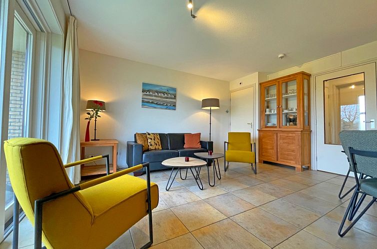 Cozy living room in Apartment Bos en Duin 41 in De Dennen, Texel with comfortable seating and lots of natural light.