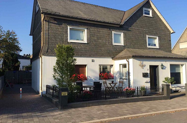 Vacation home DS021 in Winterberg, Germany, offers cozy terrace with colorful flowers.