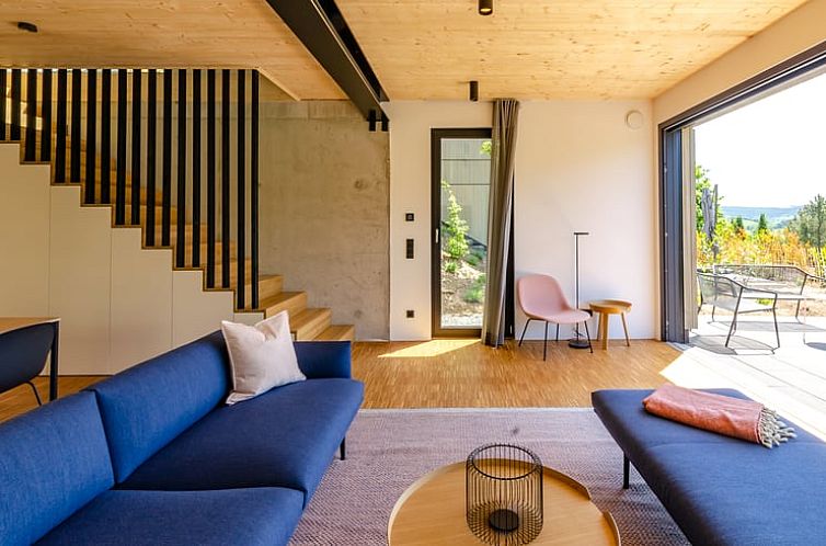 Indoor area of Holiday Home in Winterberg, Germany, with comfortable sitting area and access to sunny terrace.