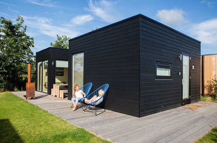 Florizand vakantiehuis in Midsland Noord, Terschelling met moderne veranda en groene omgeving.