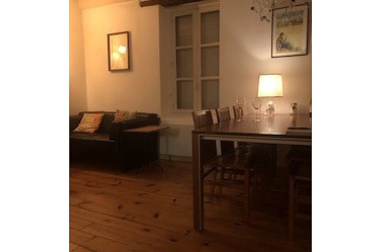 Rustic charm in the living room of Maison Les Boudards, vacation home in Durmignat, Auvergne, with warm lighting and wooden accents.