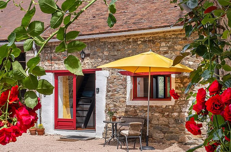 Discover the rustic charm of Cottage in Chezelle, France, with an inviting terrace surrounded by blooming nature.