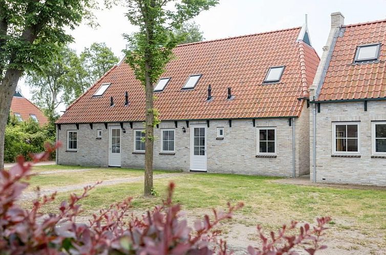 Vacation home Jasmijn in Ballum, Ameland with charming brick facade and red roof tiles.