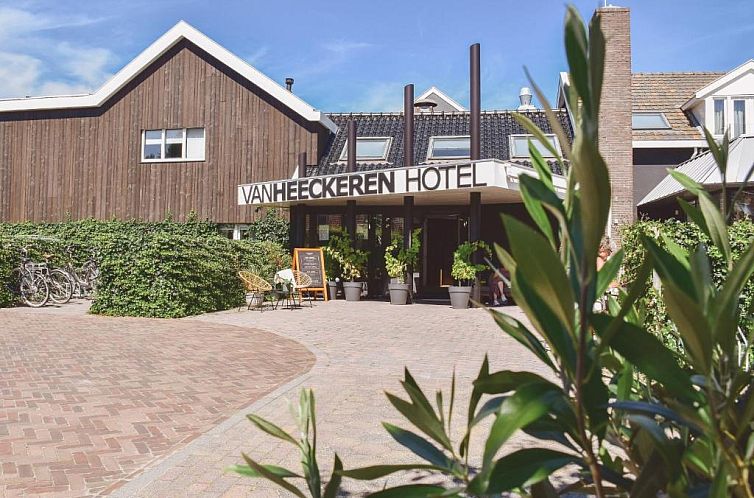 Van Heeckeren Hotel entrance in Nes, Ameland, vacation hotel surrounded by greenery and cycling.