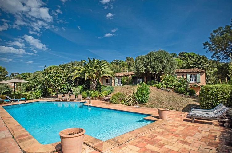 Relax by the turquoise pool of Le Bayol, a charming vacation home in La-Croix-Valmer, Provence, with beautiful gardens and rustic charm.