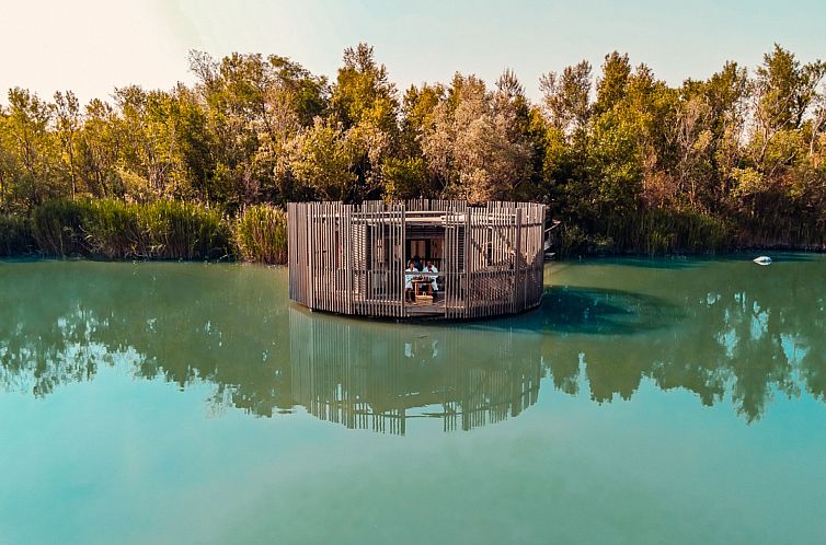Unique floating residence Aqua in Sorgues, Provence, offers tranquility amid green surroundings on the water.