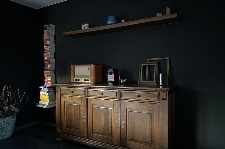 Stylish interior of Casper House, a vacation home in Lanaken, Limburg, Belgium, with vintage furniture and modern touches.