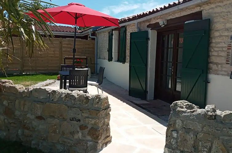 Relax on the porch of Kersenboom Gite, an idyllic vacation home in Fontenay, Upper Normandy, surrounded by nature.