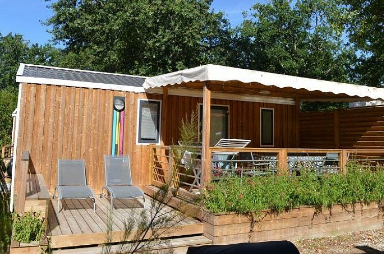 Vacation rental Mobile home Premium Clim in France with wooden veranda and nature.