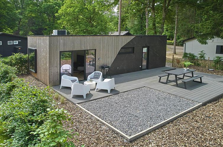 Ferienhaus De Eekhoorn in Zutendaal, Limburg, mit moderner Terrasse, umgeben von gruener Natur.