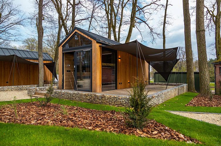 Charming Tiny House vacation home in Zutendaal, Limburg, Belgium, surrounded by nature with an inviting terrace and modern architecture.