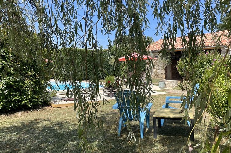 Enjoy the serene garden of Le Reve de Breuillac, a vacation home in Civray, Poitou-Charentes, with pool and lush nature.