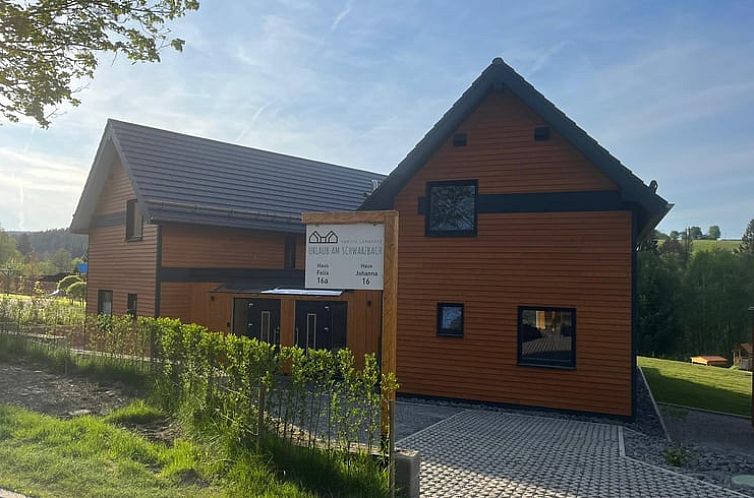 Cottage in Butgenbach-Kuchelscheid, vacation home in the Ardennes, Belgium. Modern wooden exterior with green surroundings.