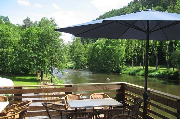 Enjoy the serene nature from the terrace of Holiday Home in Stoumont, located on the river in the Ardennes, Liege, Belgium.
