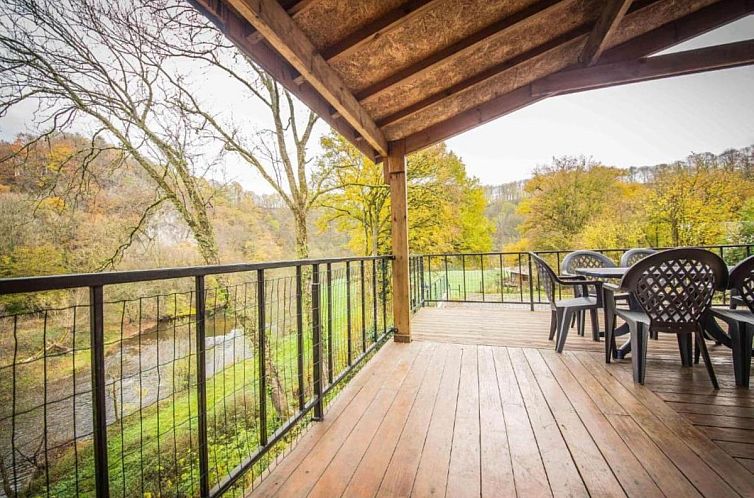 Enjoy the view from the veranda of chalet Vue sur Ourthe in Tohogne, Ardennes, surrounded by beautiful nature in Luxembourg, Belgium.