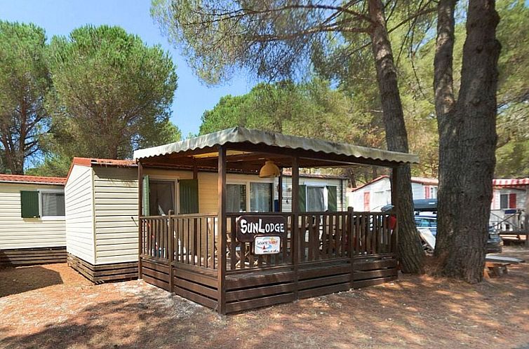 Ontdek de charme van SunLodge Redwood in Aglientu, Sardinie, met een uitnodigend terras en serene bosomgeving.