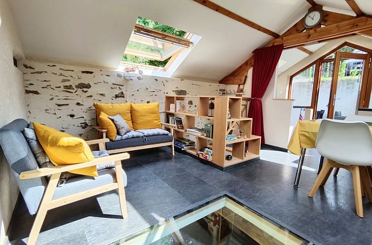 Cozy interior space of Holiday cottage in Masbourg, located in the Ardennes, Belgium, with comfortable sitting area and natural light.