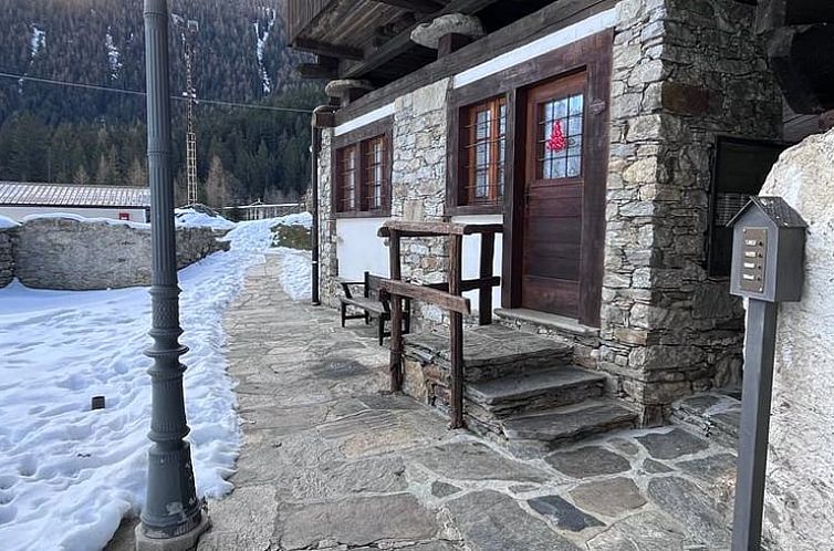 Cozy stay in Macugnaga, Piedmont: cottage with stone terrace and winter mountain setting in Italy.