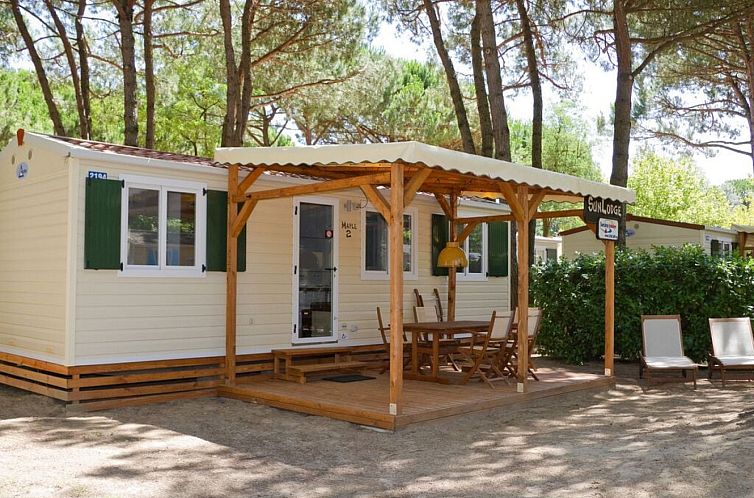 Relax on the terrace of SunLodge Maple in Cavallino-Treporti, Venice, a charming glamping lodge amid lush forests.