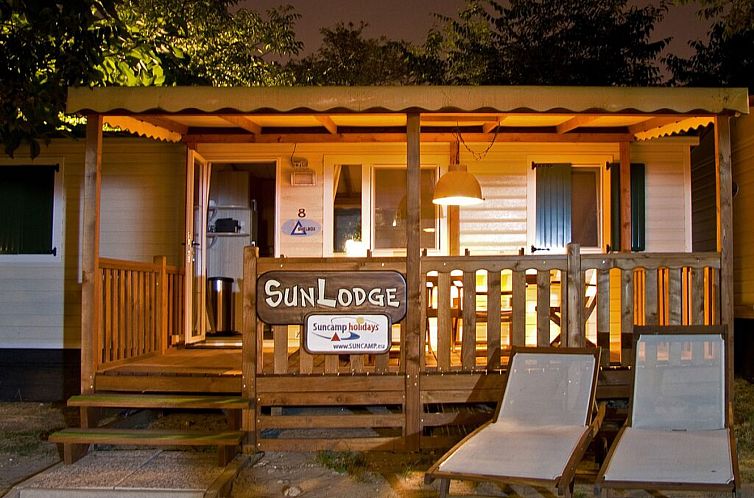 Cozy evening lighting at SunLodge Redwood vacation home in Cavallino, Venice, Italy with comfortable veranda.
