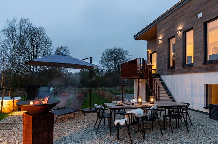 Enjoy the cozy outdoor space at Holiday Home in Nadrin, Ardennes, Belgium, with terrace and firepit for a relaxing evening.