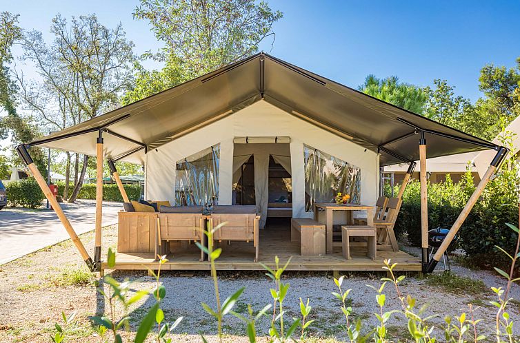 Experience glamping in the Comfort Safari Tent, Umag, Istria. This safari tent offers an inviting terrace with stunning views of the surroundings.
