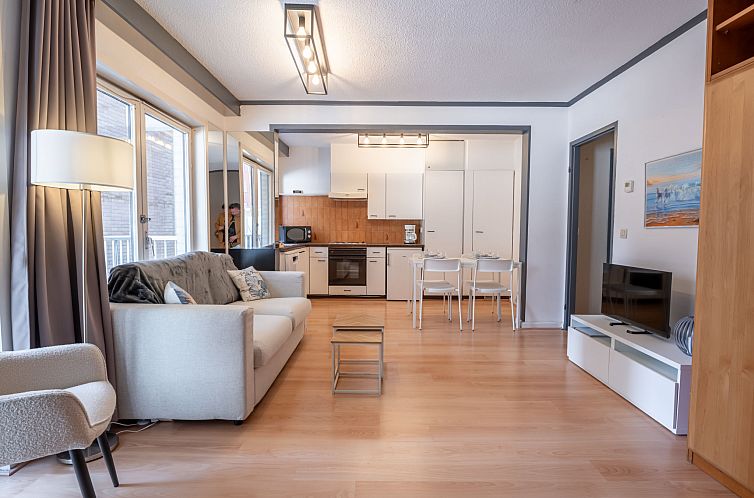 Cozy living room of Apartment Sealing with balcony in Blankenberge, Belgian coast, with modern decor and comfortable sleeping area.