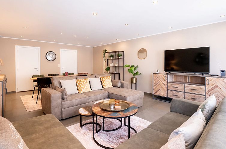 Stylish living room of Apartment Philemon with parking, located on the Belgian coast in Blankenberge, ideal for relaxation.
