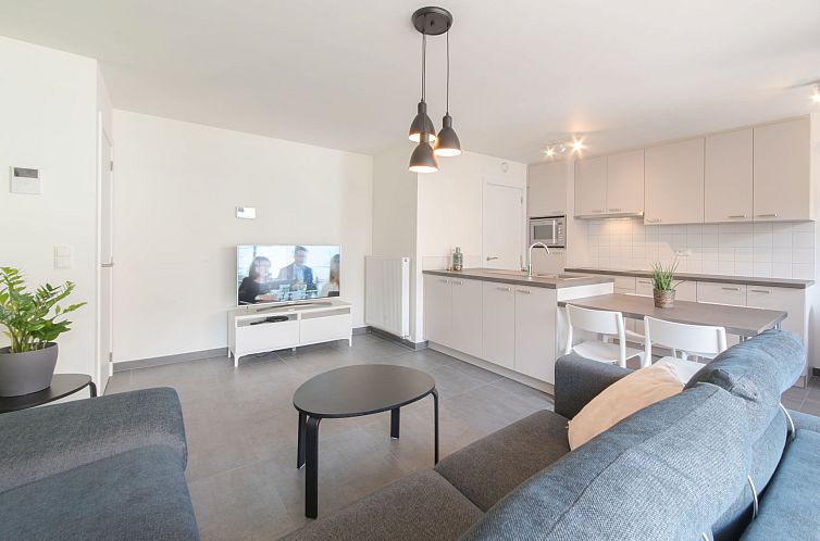 Stylish living room and kitchen of Apartment Medano in Bredene, Belgian coast, ideal vacation home with modern decor.