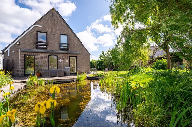 Vakantiehuis Villa Zeebries in Bredene, Belgische kust, met prachtig terras en vijver, ideaal voor een ontspannen verblijf in de natuur.