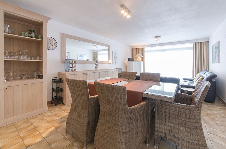 Spacious living room of Apartment 103 in Bredene on the Belgian coast, with comfortable seating and dining area for a relaxing stay.