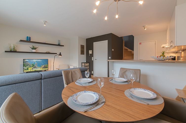 Gezellige binnenruimte van Appartement Duplex in Bredene aan de Belgische kust, met moderne eetkamer en comfortabele zithoek.