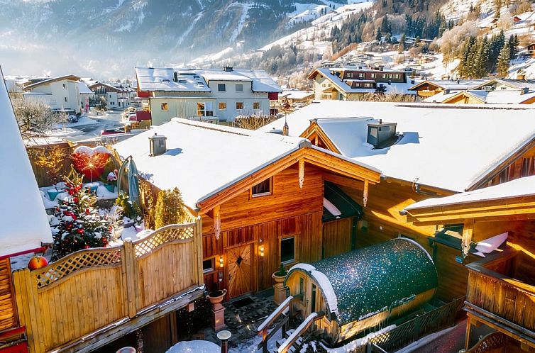 Winterlicher Charme der Adventure Lodge Kaprun, einem Chalet in Salzburg, Oesterreich, umgeben von schneebedeckten Bergen.