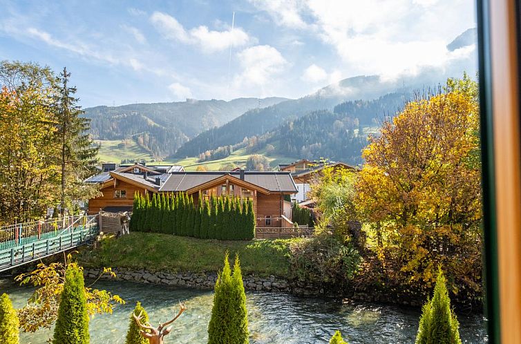 Kaprun's Nature Lodge XL, a cozy chalet in Salzburg, offers stunning views of the snow-covered surroundings and authentic wooden architecture.
