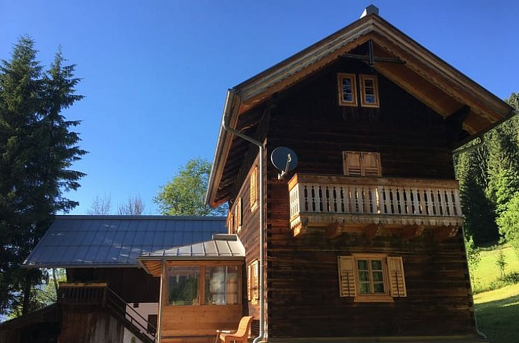 Vacation cottage House in Untertauern, Salzburg, with traditional wooden architecture and sunny balcony, perfect for nature lovers.