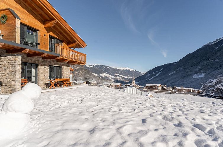 Enjoy the winter charm of Tauernlodge Krimml 2B, a vacation home in Krimml, Salzburg, with panoramic mountain views.
