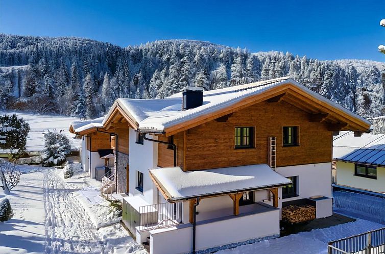 Attractive chalet Wagrainer TauernLodge 42C in Wagrain, Salzburg, with stunning views of snow-capped peaks.