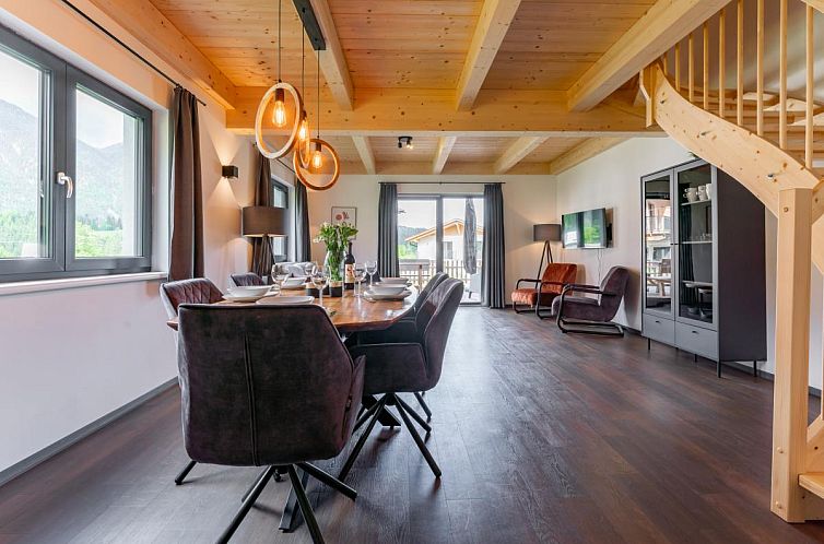 Stylish dining room in Obermoschach 6B, a vacation home in Carinthia, Austria, with warm wooden accents and mountain views.