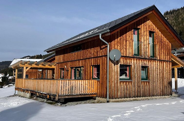 Winter charm at Chalet Spatzennest in Hohentauern, Austria with mountain views and porch.