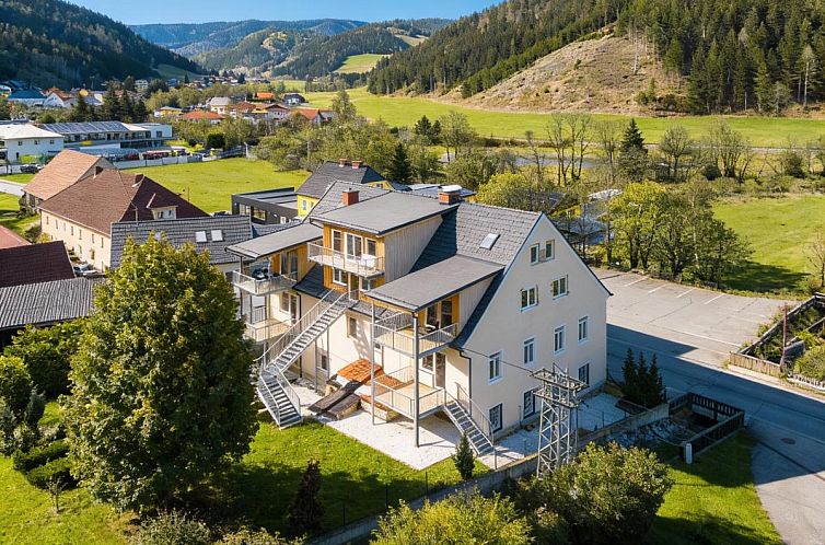 Cozy indoor area of NRV Top 7 in Moderbrugg, Styria, with spacious dining room and green surroundings.