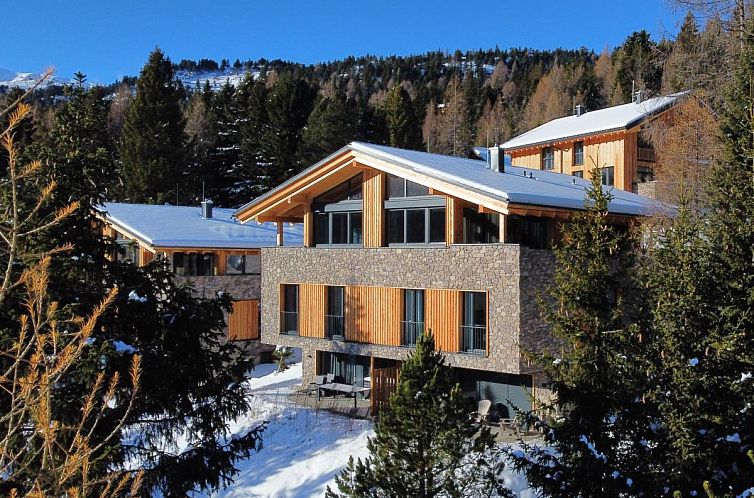 Chalet JuJa Lodge in Turracher Hohe, Austria, nestled among snow and pine forests, promises a serene vacation experience.