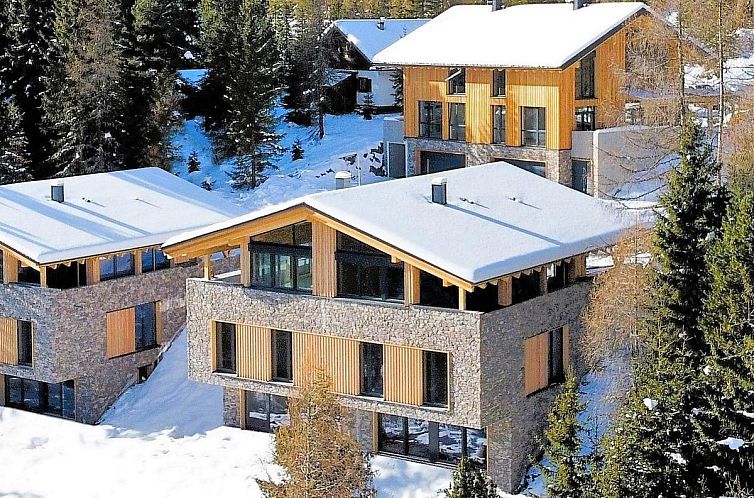Experience the Ibex Panorama Lodge, a luxury chalet in Turracher Hohe, Styria, surrounded by snow and natural beauty.