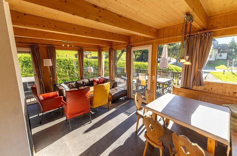 Interior of Kreischberg W1 vacation home in Styria, Austria, with spacious sitting area and terrace overlooking green surroundings.