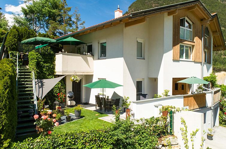Enjoy the serene winter environment at Garden Relax Apart, a vacation home in Sautens, Tyrol, surrounded by snow-capped mountains.