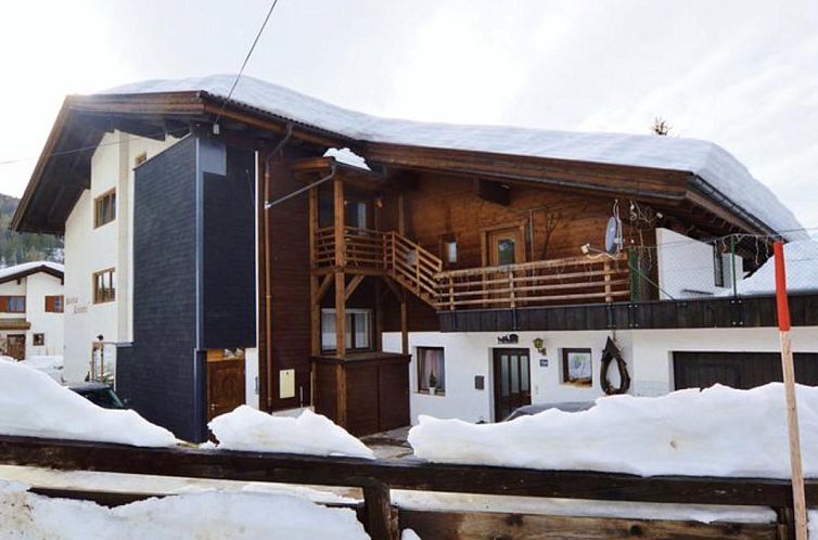 Cozy vacation home Kirschbaum 3 in the winter splendor of Ehrwald, Tyrol, surrounded by snow and mountains.