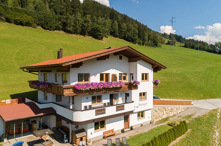 Snow covers Blasinghof in Gerlosberg, Tyrol, a charming vacation home in the midst of Alpine splendor.