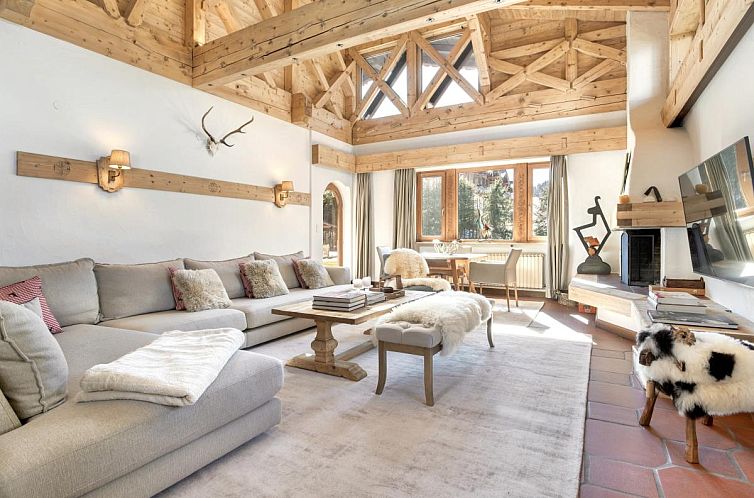 Interior of Luxury Central Kirchberg chalet in Tyrol, Austria, with an inviting seating area and rustic wooden details.