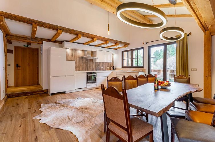 Cozy indoor area of Biber Art Chalet, vacation accommodation in Biberwier, Tyrol with spacious kitchen and dining area.