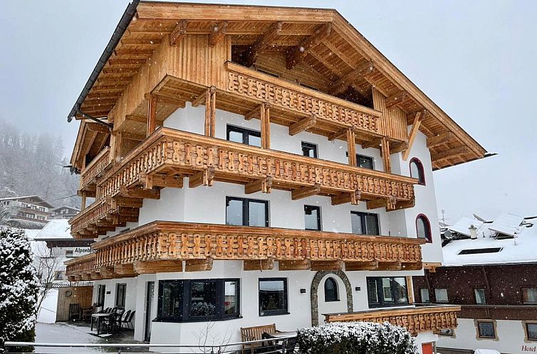 Attractive vacation home Haus Austria TOP 3 in Finkenberg, Tyrol, surrounded by snow and beautiful mountain scenery.